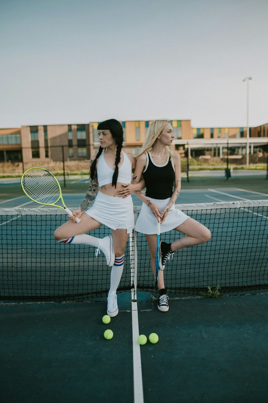 Two players posing together at the net